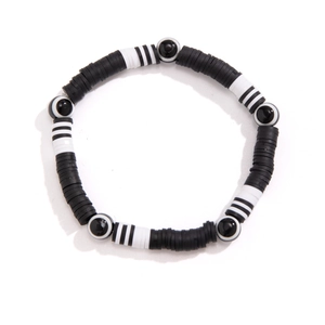 Minimalist black and white Heishi bead bracelet with mixed patterns on a white base