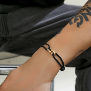 Minimalist black braided cord bracelet for men with interlocked gold rectangle charms