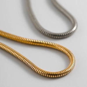 Sleek minimalist snake bone chain bracelet set in polished gold and silver finishes