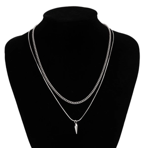 Detail showing silver layered Cuban and snake chain with a sharp cone spike pendant