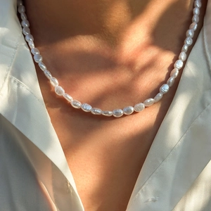 Mens vintage baroque pearl necklace with natural luster worn over a white shirt