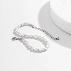 Detailed macro view of baroque pearl bracelet with silver lobster clasp and extender chain