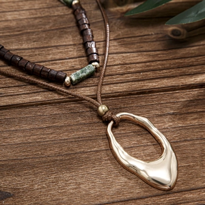 Men's bohemian double-layered necklace set featuring wood beads and oval metal pendant