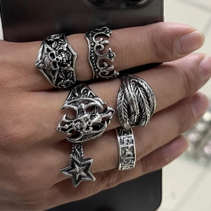 Men's 6-piece punk skull and crown ring set in vintage silver finish on model's hand