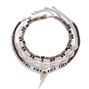 Bohemian multilayer coconut shell bead necklace with shell and shark tooth pendant