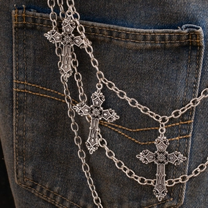 Detail of multi-layer silver hip hop wallet chain with three baroque embossed crosses