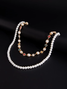 Detail of double-layer pearl necklace with colorful gemstones and gold-plated hardware