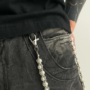 Detail of hip hop pearl trousers chain with silver metal links and lobster clasp closure