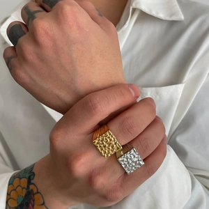 Close-up of nugget style square men's ring with textured surface in gold and silver