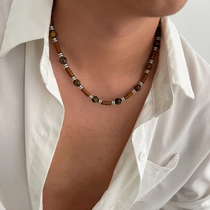 Detail of men's beaded necklace with brown tiger eye stones and wooden cylinders