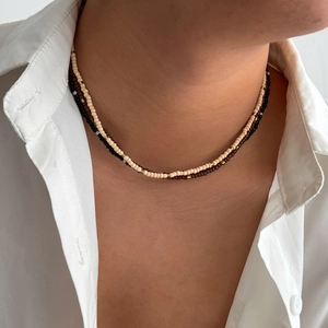 Bohemian layered seed bead necklace in beige and brown with gold spacers on model
