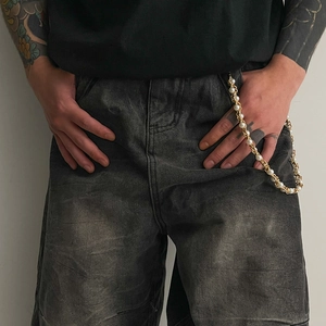 Hip hop pearl and gold metal trousers chain accessory on dark gray wash jeans