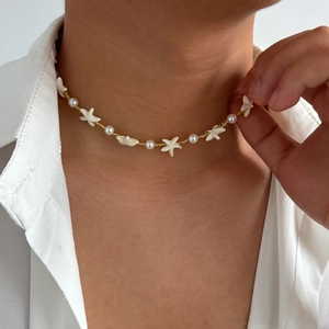 Mens pearl choker necklace with starfish charms and gold beads for a trendy beach holiday style