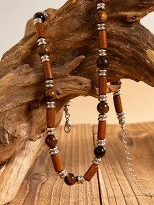 Close-up of vintage wood beads and tiger eye stones on a natural ethnic necklace