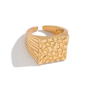 Men's gold nugget style square signet ring with textured finish on a white background