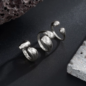 Three-piece silver droplet rings set with polished liquid metal organic design