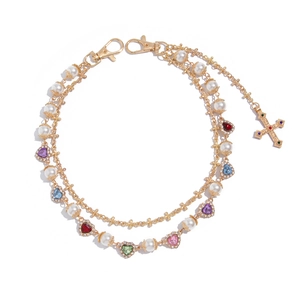 Multilayer gold chain with pearls, colorful heart charms, and a jeweled cross pendant