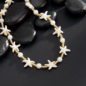 Starfish beaded necklace with white pearls and amber glass beads on black stones