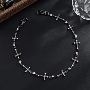 Detail view of gothic gunmetal trouser chain with crystal-studded cross pendants