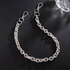 Close-up of gothic silver skull links on a metal pant chain with spring hooks