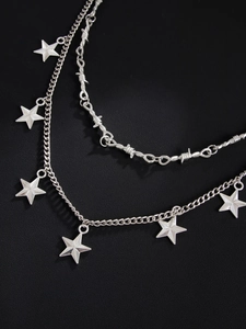 Close-up of double-layer silver punk chain with barbed wire design and metal stars