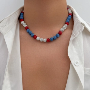 Close-up of men's beaded necklace with red white and blue rhinestone encrusted spheres