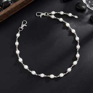 Men's pearl trousers chain with silver lobster clasps on a stylish black textured background