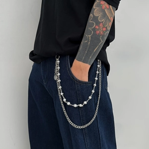 Double-layered silver pant chain featuring polished metal links and white pearls on jeans