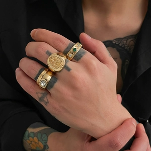 Vintage gold ring set featuring baroque relief and zircon stones on a model hand