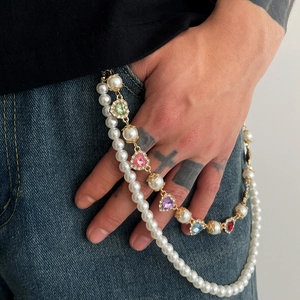 Multilayer pearl and colorful heart gemstone pants chain with gold hooks on blue denim