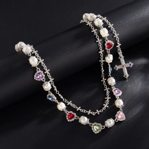 Double-layered silver necklace with pearls, cross pendant, and colorful heart gemstones