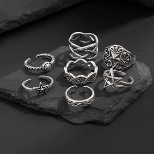 Detail of 7-piece vintage silver alloy ring set with star and braided textures on stone