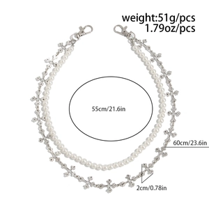 Detail showing double-layered hip hop jean chain with pearls and silver metal crosses