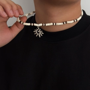 Collier bohème pour homme avec pendentif tournesol et perles marron et blanc sur modèle