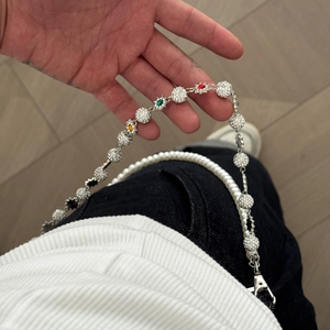 Detail of hip hop pants chain with sparkling crystal balls, pearls and colorful flower charms