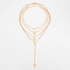 Vue de dessus détaillée de colliers dorés avec pendentifs croix et médaille de la Vierge