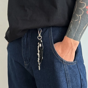 Porte-clés style urbain avec perles argentées, cordon en cuir noir et chaînes multicouches