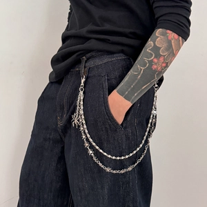 Punk silver multi-layer trouser chain featuring spider charms on denim jeans for men