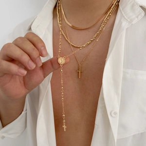 Mens gold layered necklace set with cross pendant and snake chain on model