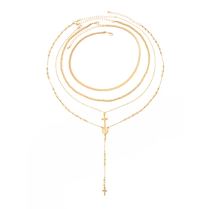 Gold layered necklace set featuring flat snake chain and cross pendant on white background