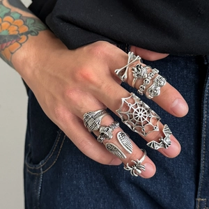 Gothic silver punk rings set with spider web skull and bat designs for stacked men's style