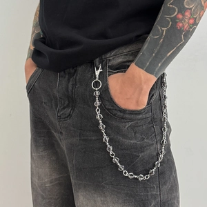 Silver alloy trousers chain with vintage gothic links worn on dark denim jeans