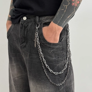 Double-layer silver metal pants chain with punk dagger pendant on grey denim jeans