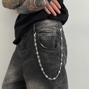 Silver skull wallet chain with barbed wire links on grey denim jeans for men