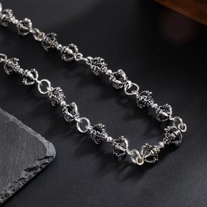 Detail of punk silver metal wallet chain with vintage crown links and oxidized finish