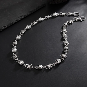 Detail of vintage silver skull and barbed wire link trousers chain with lobster clasp