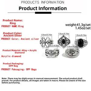 Close-up of a 5-piece retro silver alloy ring set with black acrylic stone engravings