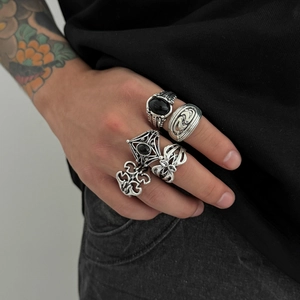 Detail of five men's vintage silver rings with black gemstones and gothic engravings