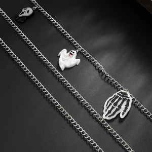 Detail of Halloween ghost charms and skull hand on multilayer punk gothic chain accessory