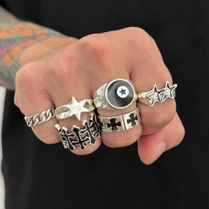 Close-up of punk style rings set with five-pointed star and gothic vintage designs